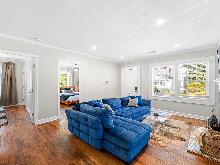 The living room is a chic and inviting space, featuring a comfortable couch that beckons you to unwind and enjoy the comfort of home.