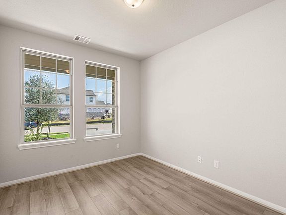 The flex space is perfect for a home office and features French doors, beautiful floors and large wi