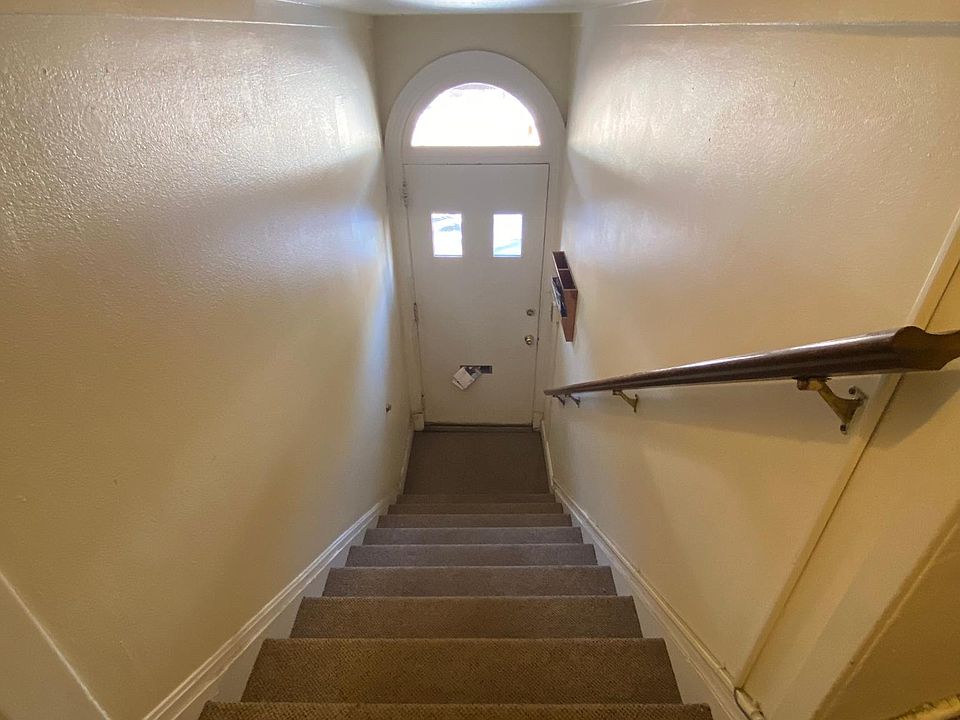 Front door with an indoor private stair case leading you into your apartment