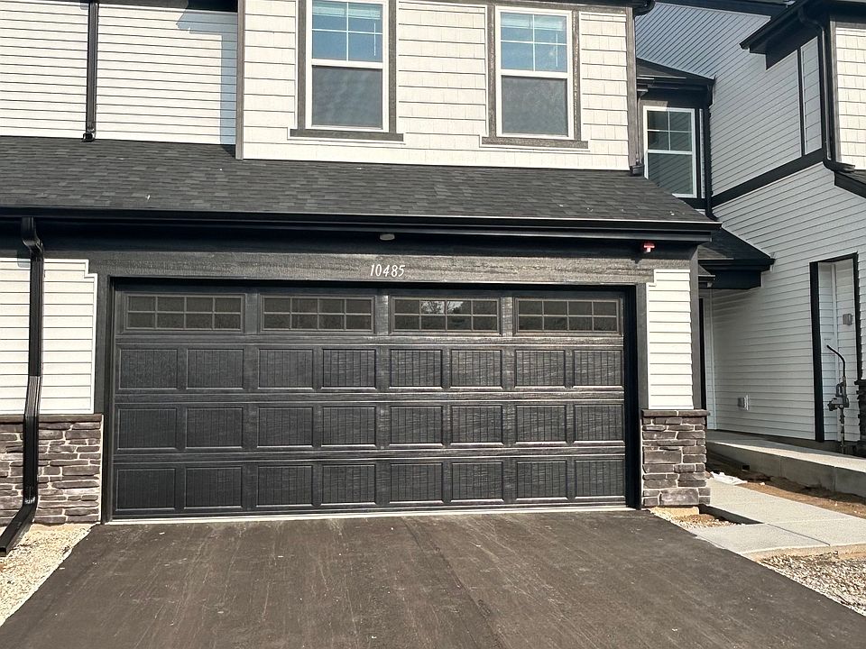Front exterior, large driveway with room for two vehicles.