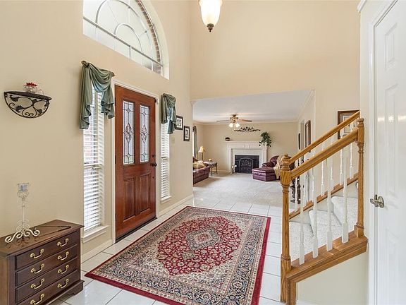 View from the dining room of the family room and the foyer. Very open and bright.