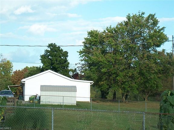 A utility building nearby provides additional storage.