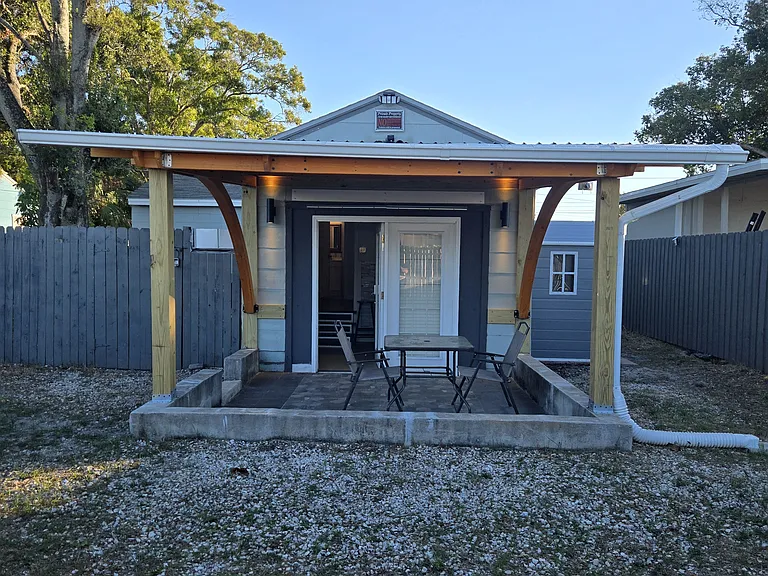 Large covered patio with outdoor furniture provided.
