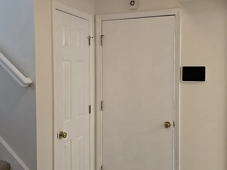 Downstairs landing, coat closet, and garage entrance
