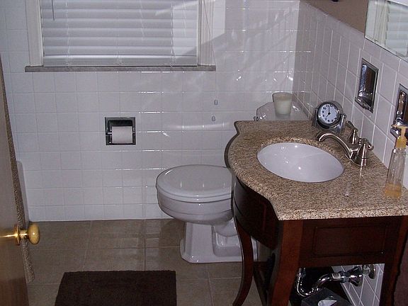 First floor bath has granite countertop and Italian tile floor.