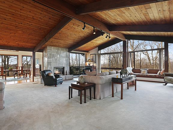 Living room with walls of windows, vaulted ceiling