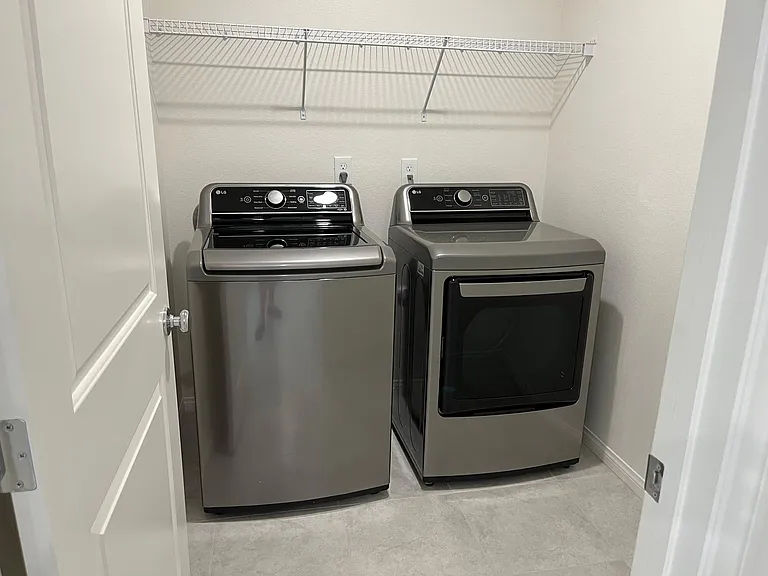 Brand new LG washer and dryer in laundry room