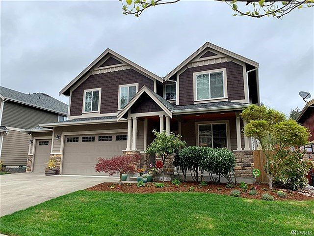 Front of home with a nicely landscaped front yard.