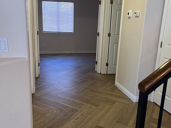 Hallway ilooking into office.
Powder room on right- hand side with coat closet beside stairway