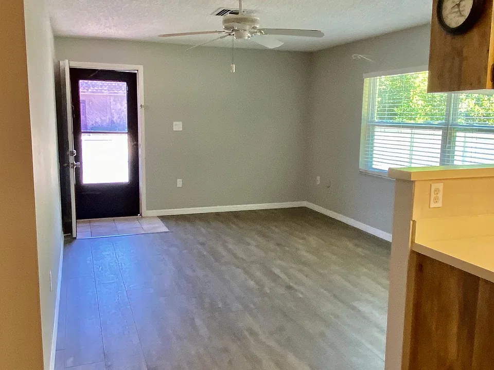View looking toward front room and entrance from dining area.