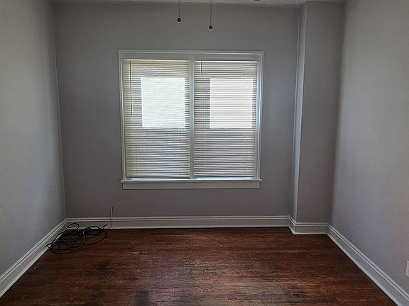 Freshly-painted bedroom #2 with new fan and blinds.