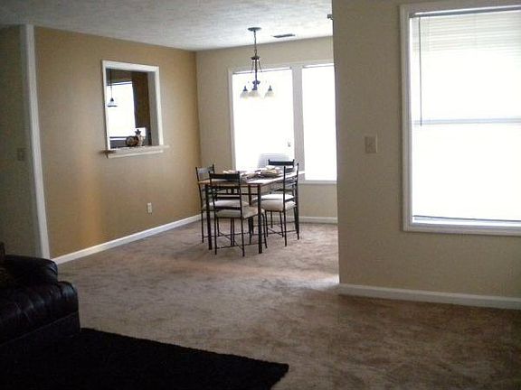 Dining area has a window opening to Kitchen and sliding door to Patio.
