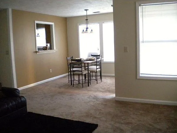 Dining area has a window opening to Kitchen and sliding door to Patio.