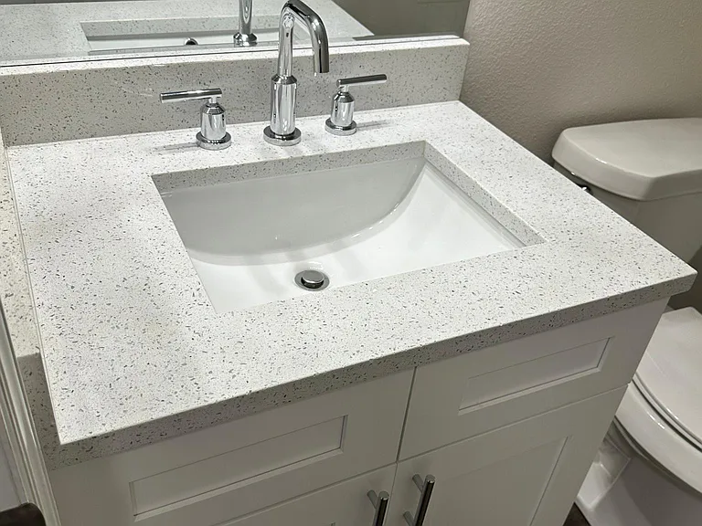 Common bathroom, quartz counter tops and modern Moen fixtures