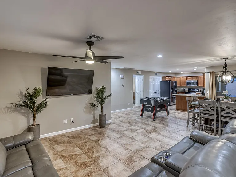 Generous living area with large windows providing natural light and neighborhood views.