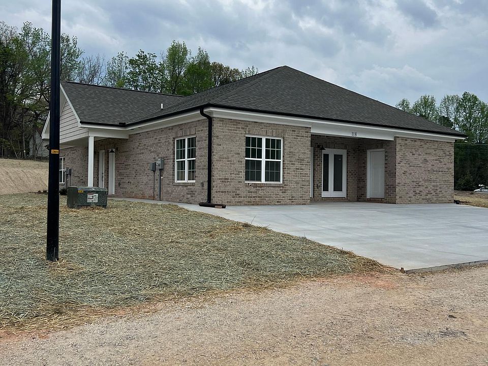 Outside of units. All brick with concrete pad for parking.