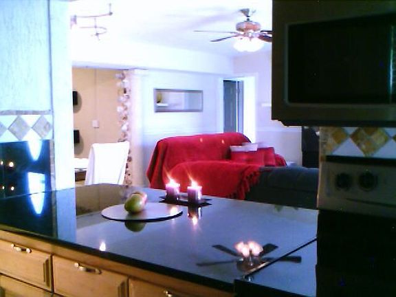 Open kitchen w/ granite slab countertops 