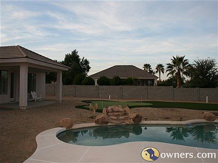 The backyard pool and putting green