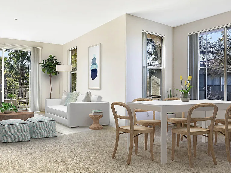 Carpeted Living Room with Balcony