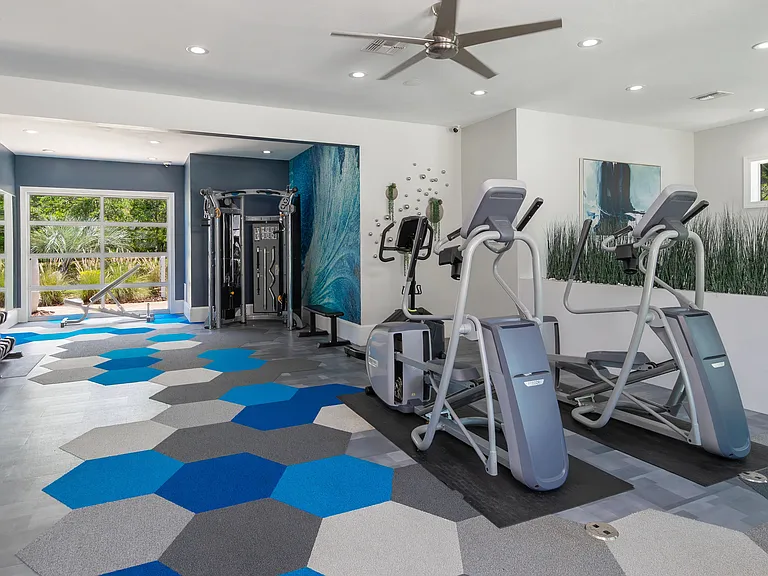 Whether you're hitting the elliptical or strength training, our modern gym space offers a colorful, motivating setting to crush your goals.