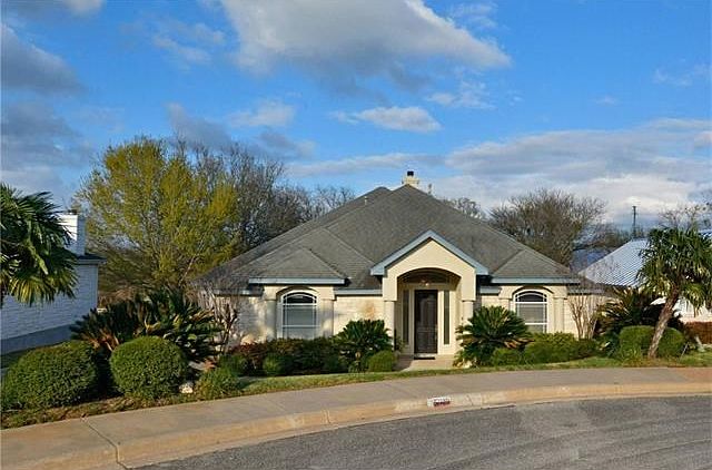 This home is situated in the private golf club community of Onion Creek and is toward the end of a cul-de-sac street. and backs up to the number 12 fairway. It has a stone exterior and composition roof. The mature landscaping is supported by a partial spr
