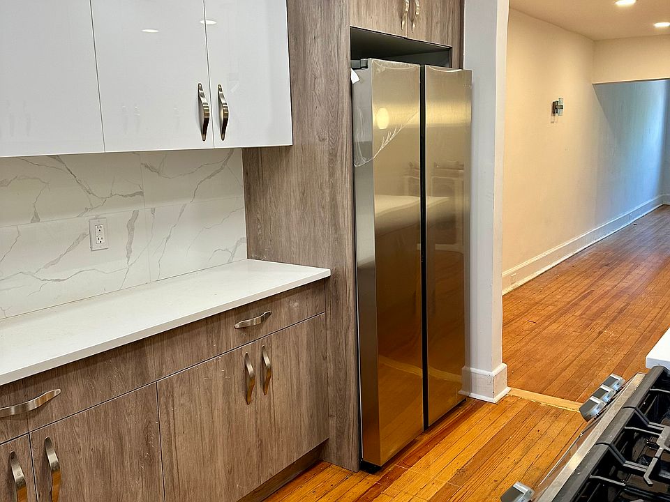 Family kitchen with modern SAMSUNG stainless steel large capacity vertical side by side Refrigerator/Freezer.