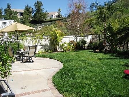 Generaus pool size yard with grassy area.