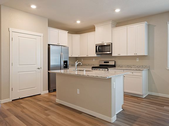 Gorgeous kitchen has oversized cabinets and beautiful granite countertops