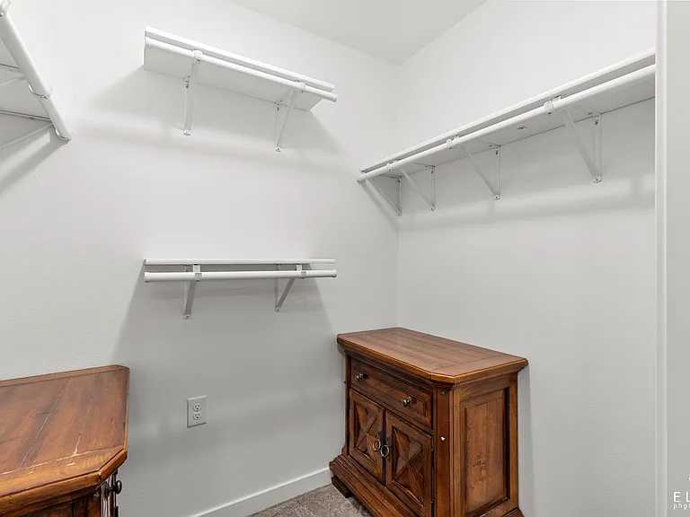 Master suite walk-in closet.
*note: side tables not included.
