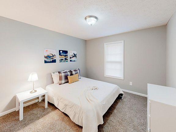 Spacious bedroom featuring a queen bed, nightstand, dresser and reach-in closet.