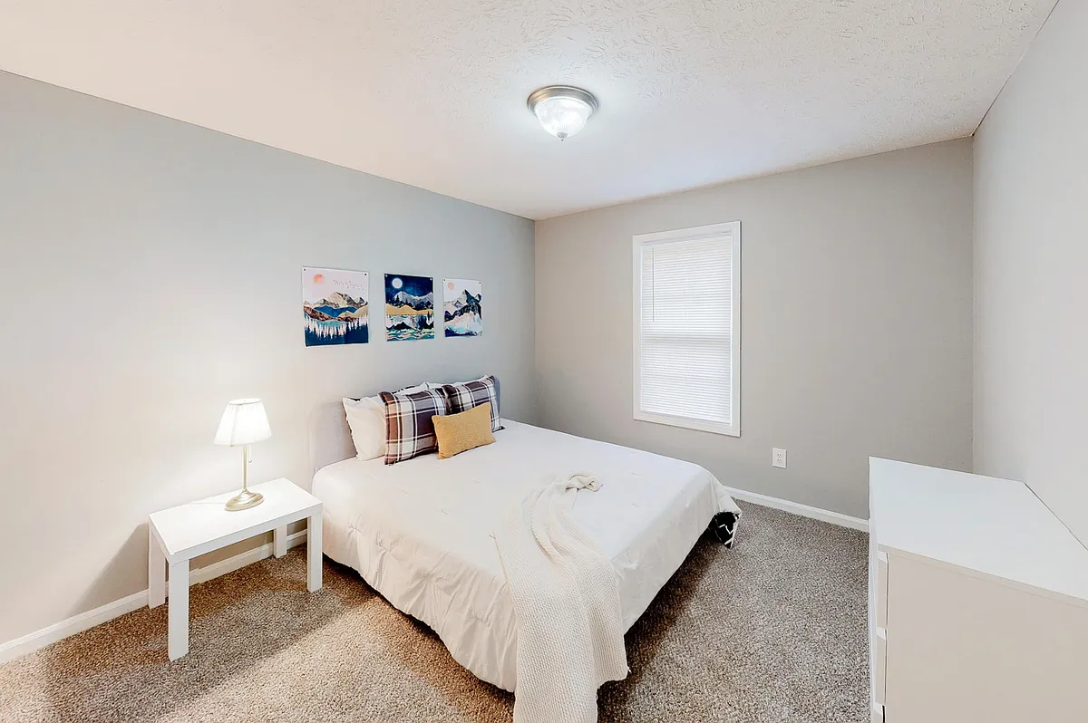 Spacious bedroom featuring a queen bed, nightstand, dresser and reach-in closet. - Pilgrim Way NE