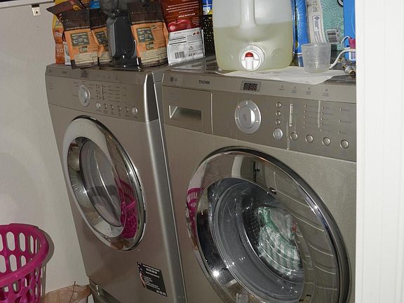 Washer and dryer set in the laundry room. Located on ground level.