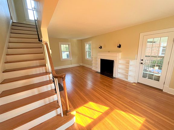 Living Room with built in shelving and wood burning fireplace.