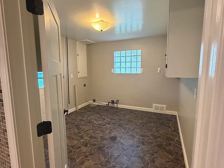 Laundry room off kitchen and garage.