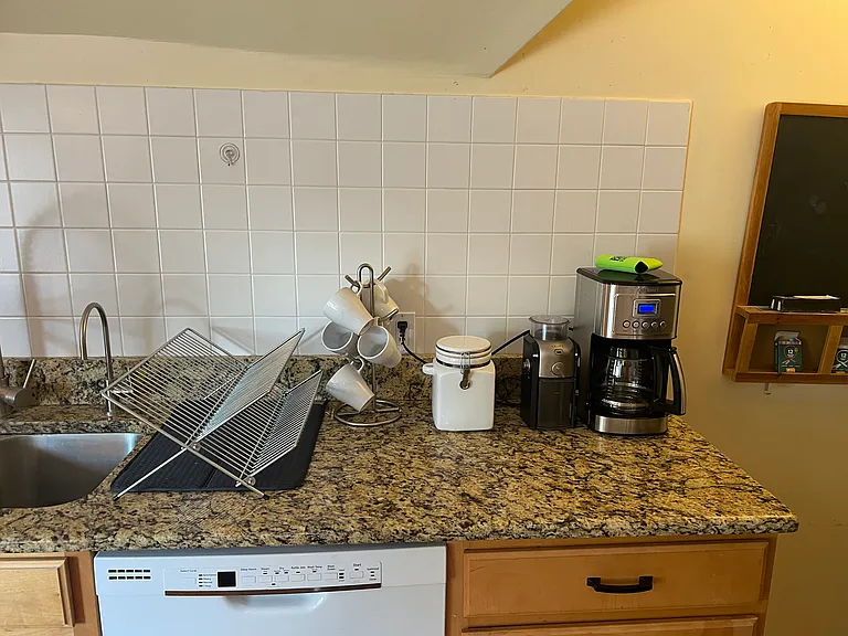 Cuisineart Coffee Maker, Coffee Grinder, Granite Countertops, and Dishwasher; along with all kitchen furnishings.