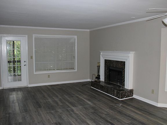 Living room with fireplace, new flooring and paint