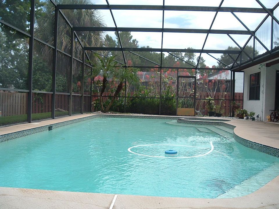 Huge swimming pool and spa fully screened.