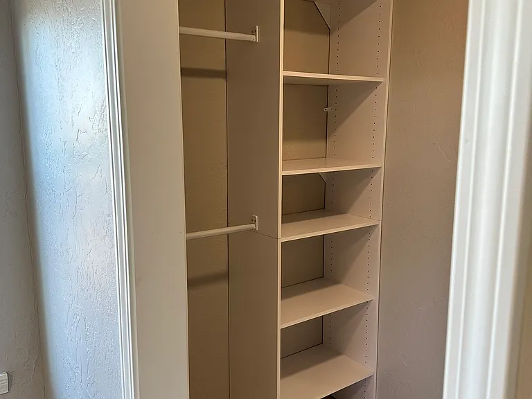 Left side of Walking closet with cabinet for primary bedroom