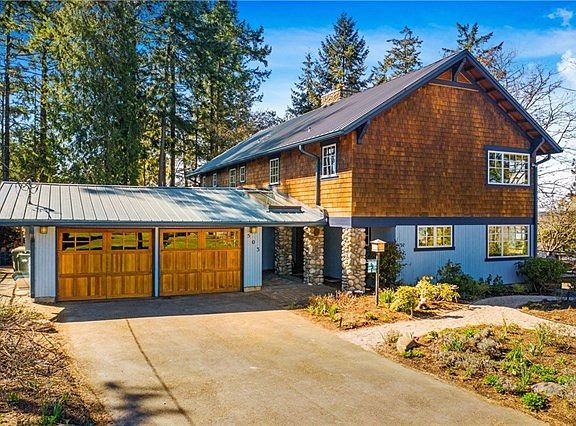 Attached 2 car garage with garage doors on both ends  allowing drive- through to the detached shop behind.