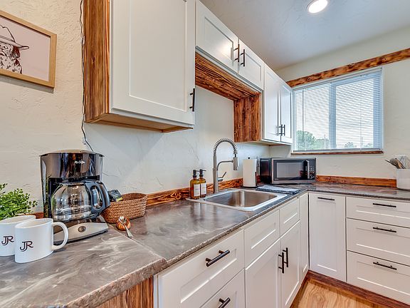 Kitchen includes dishes, silverware, pots & pans, toaster, coffee maker, hot plate, and multi-function oven/microwave/air fryer.