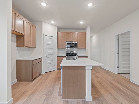 Kitchen in the Pearl home plan by Trophy Signature Homes - REPRESENTATIVE PHOTO