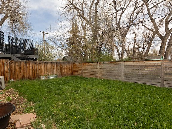 Fenced yard with fire pit, garden, and room to hangout and play with pets