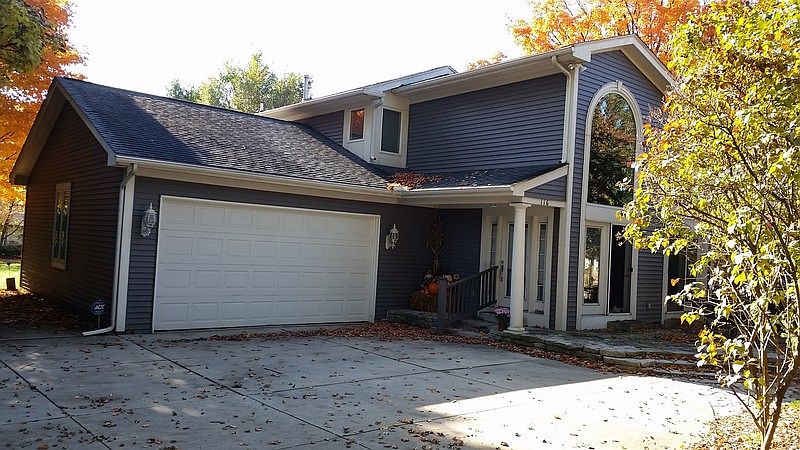 Front of home, patio, & 2-car garage