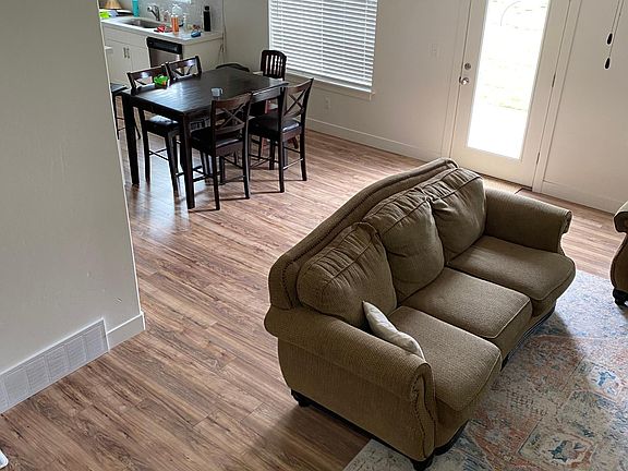 dinning area and living room with door to backyard