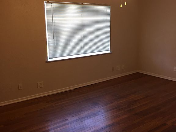 Living Room area. Hardwoods, Ceiling fan. Nice street view