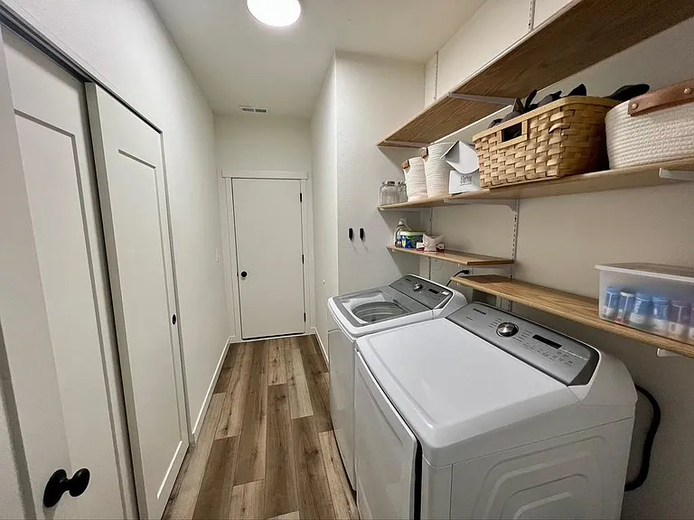 Garage entrance to laundry room with washer and dryer.