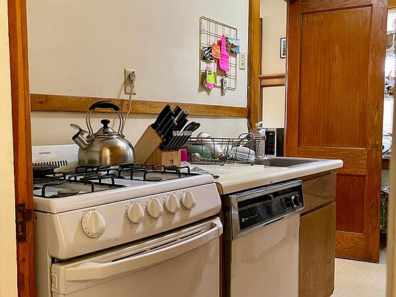 Gas range and dishwasher in galley style kitchen.