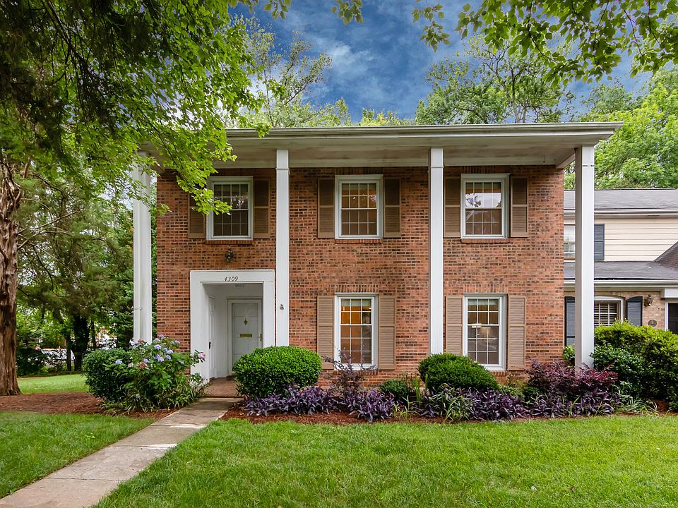 The brick and the covered front porch make for gorgeous curb appeal