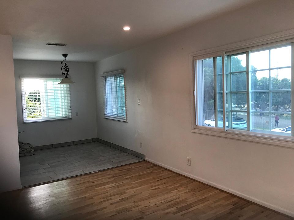 front door living room dining room view. Lots of Natural light and breeze. No structural obstruction