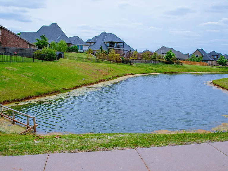 Small Lake/Pond across the street. Rose Creek Neighborhood borders next to this small neighborhood and you can see it where the black iron fence line is.